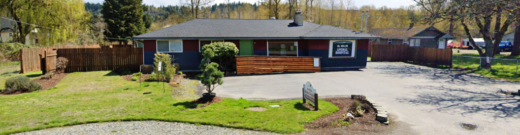 Single-story commercial building operating as an animal hospital with a wood-panel sign.